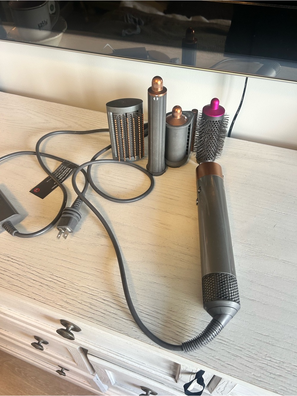 Dyson air dryer with attachments.